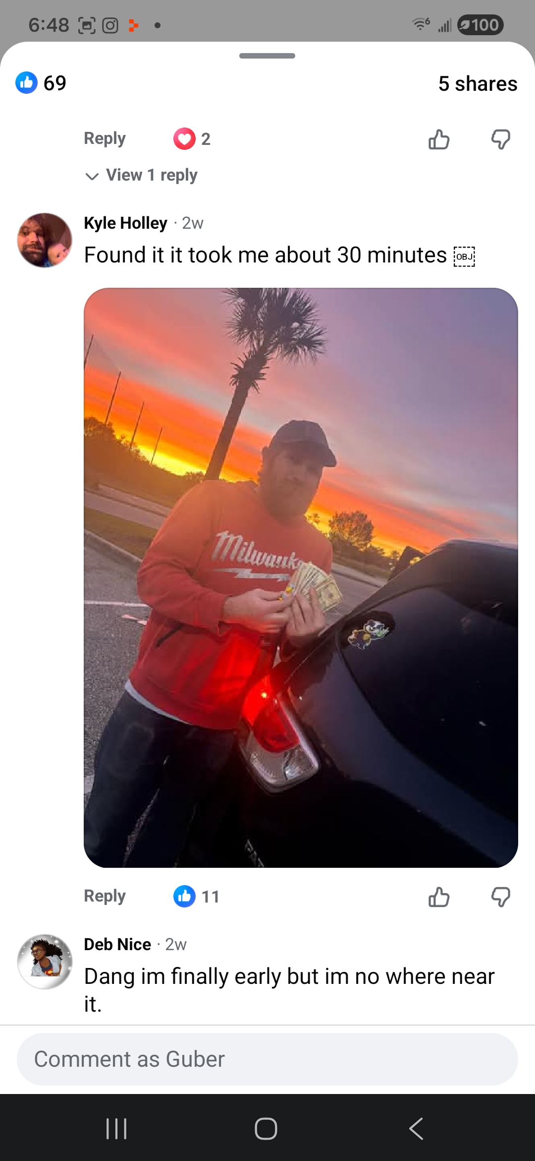 Kyle Holley with cash at sunset after finding a GUBER Cash Drop